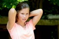 Young teenage girl in the park with calm facial expression. Royalty Free Stock Photo