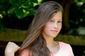 Young teenage girl in the park with calm facial expression. Royalty Free Stock Photo