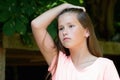 Young teenage girl in the park with sorrow facial expression. Royalty Free Stock Photo