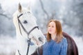 Young teenage girl with white horse in winter park Royalty Free Stock Photo