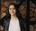 A young teenage girl poses in front of a fireplace logs Royalty Free Stock Photo