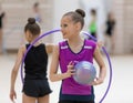 A young teenage girl prepares for performance, warming up and performs gymnastic elements at the competitions.