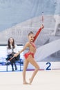 A young teenage girl prepares for performance, warming up and performs gymnastic elements at the competitions.