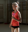 A young teenage girl prepares for performance, warming up and performs gymnastic elements at the competitions.