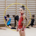 A young teenage girl prepares for performance, warming up and performs gymnastic elements at the competitions.
