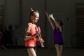 A young teenage girl prepares for performance, warming up and performs gymnastic elements at the competitions.