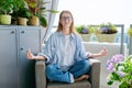 Young teenage girl relaxing meditating at home with her eyes closed in lotus position Royalty Free Stock Photo