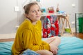 Young teenage girl sitting in cross-legs on the bed Royalty Free Stock Photo