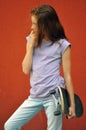 Young teenage girl with skateboard in the street Royalty Free Stock Photo