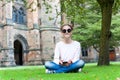 Young teenage girl with smartphone sitting in Glasgow University