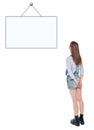 Young teenage girl standing and looking on empty picture frame Royalty Free Stock Photo
