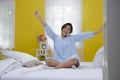 Young teenage girl stretching in bed Royalty Free Stock Photo