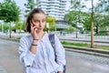 Young teenage girl talking on phone, outdoor on street of modern city Royalty Free Stock Photo