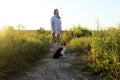 Young Teenage Girl Walking With Her Tuxedo Cat. Owner And Pet Outdoors. Children, Animals, Pets concept.