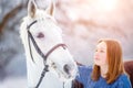 Young teenage girl with white horse in winter park Royalty Free Stock Photo