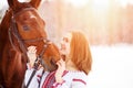 Young teenage happy girl with horse in winter park Royalty Free Stock Photo