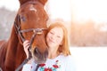 Young teenage happy girl with horse in winter park Royalty Free Stock Photo