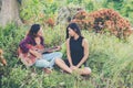 Young teenage looking at her female friend while playing guitar,Relaxing time enjoyment.