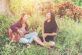 Young teenage looking at her female friend while playing guitar,Relaxing time enjoyment.