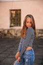 Young teenage poses for photo. blonde girl in jeans and blouse Royalty Free Stock Photo
