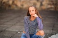 Young teenage poses for photo. blonde girl in jeans and blouse Royalty Free Stock Photo