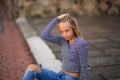 Young teenage poses for photo. blonde girl in jeans and blouse Royalty Free Stock Photo