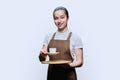 Young teenage female waitress holding tray with cup of coffee, on white background