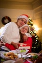 A young teenage woman hugs with mother is holding a gift happily at Christmas celebrations and family dinners