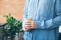 Young teenager in blue casual jeans shirt is drinking coffee. Royalty Free Stock Photo