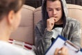 Young teenager boy at counseling - biting nails immersed in thoughts, close up Royalty Free Stock Photo