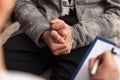 Young teenager boy at counseling - close up on hands Royalty Free Stock Photo