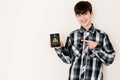 Young teenager boy holding Haiti passport looking positive and happy standing and smiling with a confident smile against white