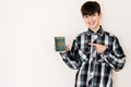 Young teenager boy holding Mexico passport looking positive and happy standing and smiling with a confident smile against white