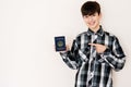 Young teenager boy holding Micronesia passport looking positive and happy standing and smiling with a confident smile against