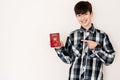 Young teenager boy holding Oman passport looking positive and happy standing and smiling with a confident smile against white Royalty Free Stock Photo