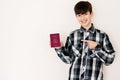 Young teenager boy holding Spain passport looking positive and happy standing and smiling with a confident smile against white Royalty Free Stock Photo