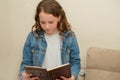 Young Teenager Child Reading Book. Beautiful Jewish Caucasian Girl Reads Passover Haggadah During Passover Seder In Home Royalty Free Stock Photo