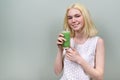 Young teenager girl with green vegetable smoothie drink, healthy vegan diet, copy space