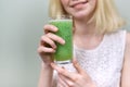 Young teenager girl with green vegetable smoothie drink, healthy vegan diet, copy space Royalty Free Stock Photo