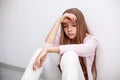 Young teenager girl having a heartache - sitting on the floor by Royalty Free Stock Photo