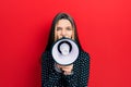 Young teenager girl shouthing and screaming with megaphone Royalty Free Stock Photo