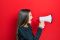 Young teenager girl shouthing and screaming with megaphone Royalty Free Stock Photo