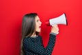 Young teenager girl shouthing and screaming with megaphone Royalty Free Stock Photo