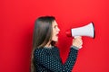 Young teenager girl shouthing and screaming with megaphone Royalty Free Stock Photo