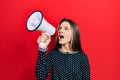 Young teenager girl shouthing and screaming with megaphone Royalty Free Stock Photo