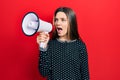 Young teenager girl shouthing and screaming with megaphone Royalty Free Stock Photo