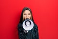 Young teenager girl shouthing and screaming with megaphone Royalty Free Stock Photo