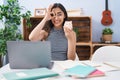 Young teenager girl studying using computer laptop smiling happy doing ok sign with hand on eye looking through fingers Royalty Free Stock Photo