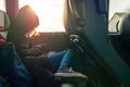 Young teenager girl on a trip in a bus watching movie on her smart phone. Kids attached to modern technology concept. The model Royalty Free Stock Photo