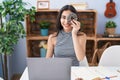 Young teenager girl using computer laptop with doughnut on face looking positive and happy standing and smiling with a confident Royalty Free Stock Photo